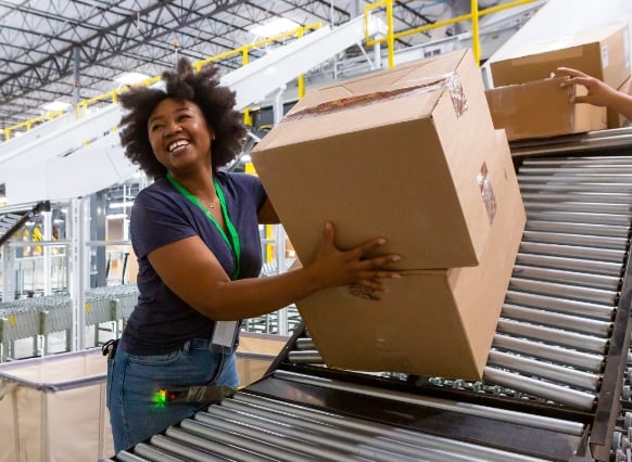 Warehouse worker processing packages for e-commerce fulfillment
